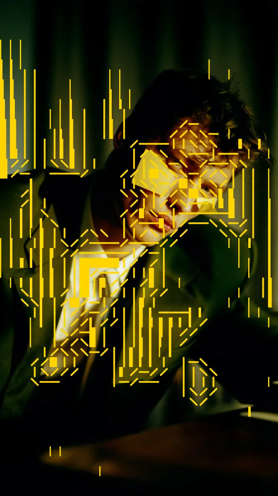 ASCII Art Effect on a photo of a man in a suit under yellow light