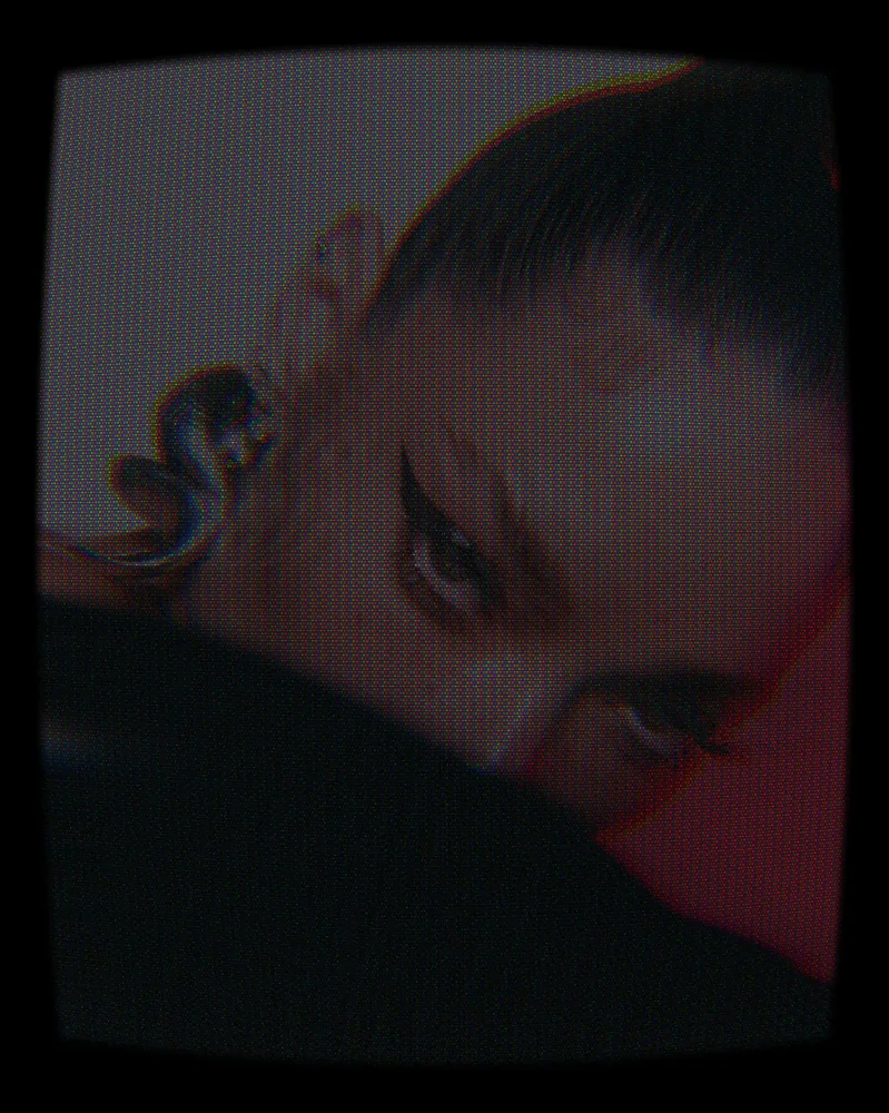 CCTV Effect on a photo of a woman with a silver earring and winged liner
