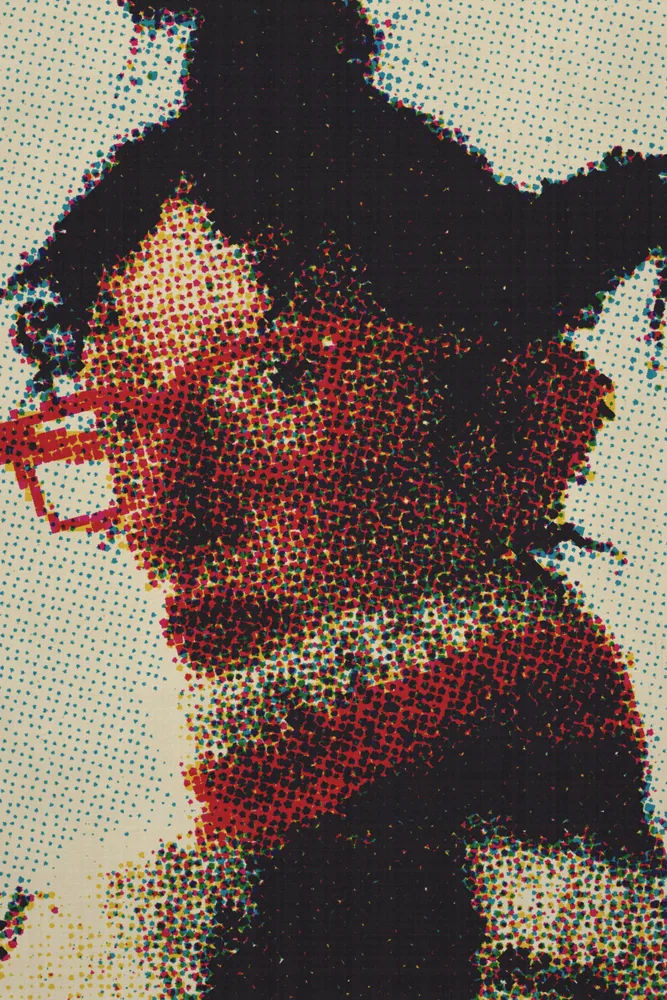 CMYK Effect on a photo of a woman in orange glasses and a knit collar