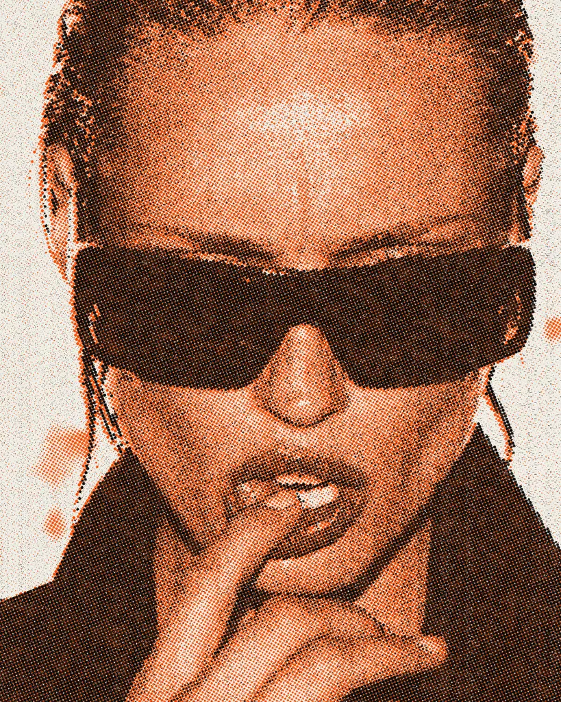 The same portrait printed as coarse halftone dots in dark brown and orange on speckled off-white paper, with loose orange splashes near the edges.